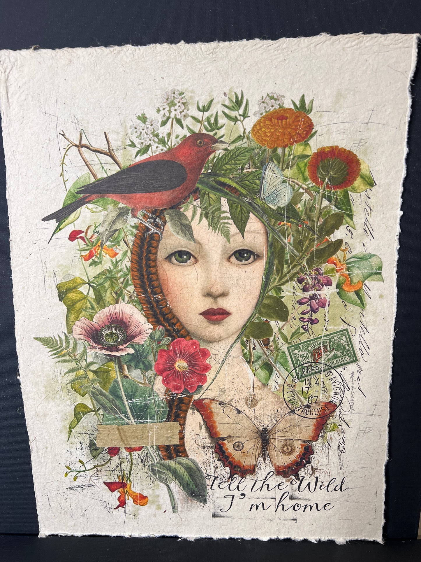Artistic collage with a face surrounded by flowers, birds, and text on textured paper.