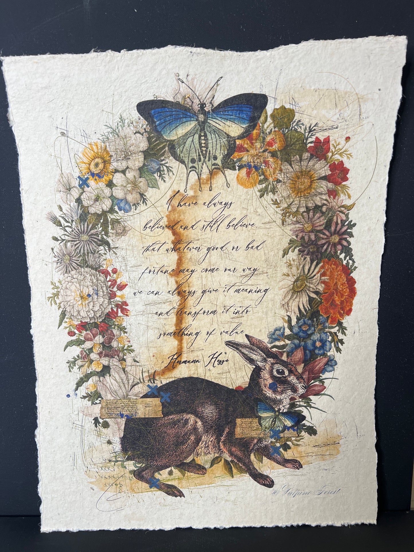 Decorative paper with a rabbit, butterfly, and floral design on a dark background