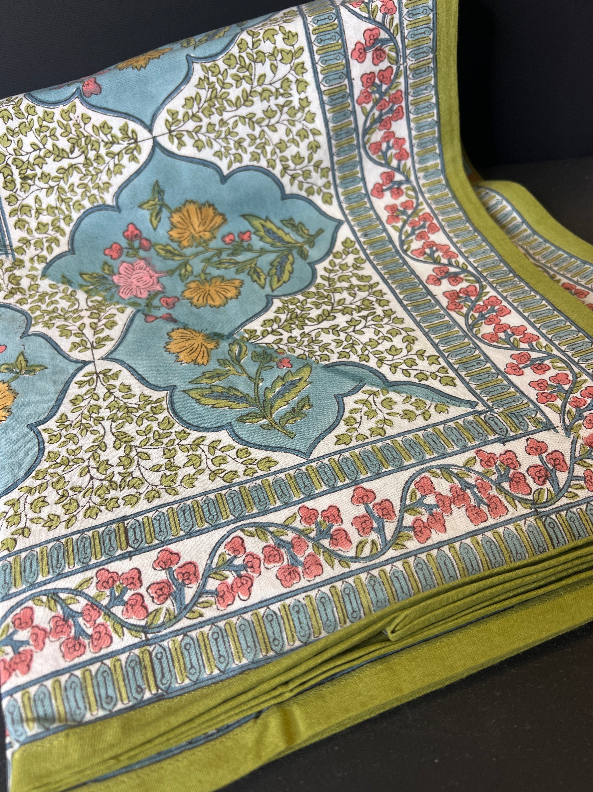 Close-up of a fabric with floral and geometric patterns on a dark background