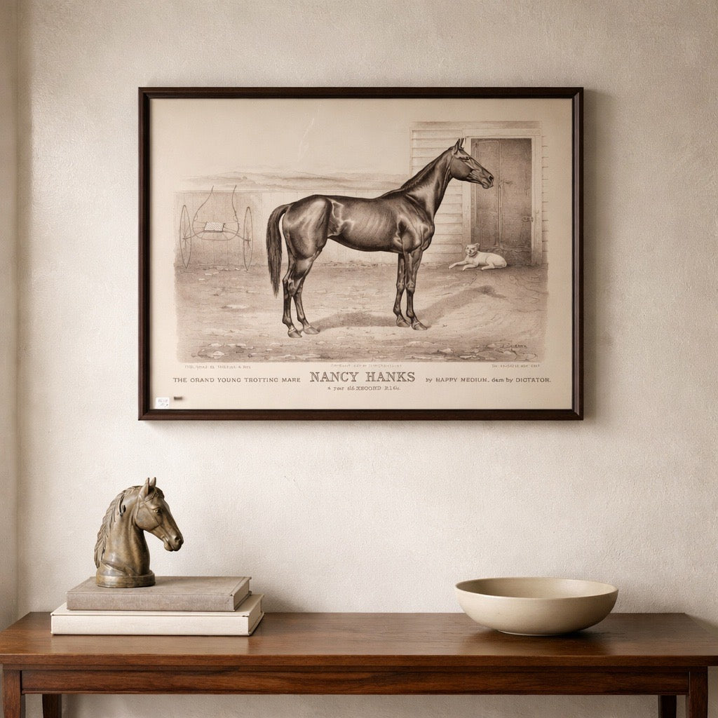 Framed artwork of a horse on a wall above a wooden table with decorative items.
