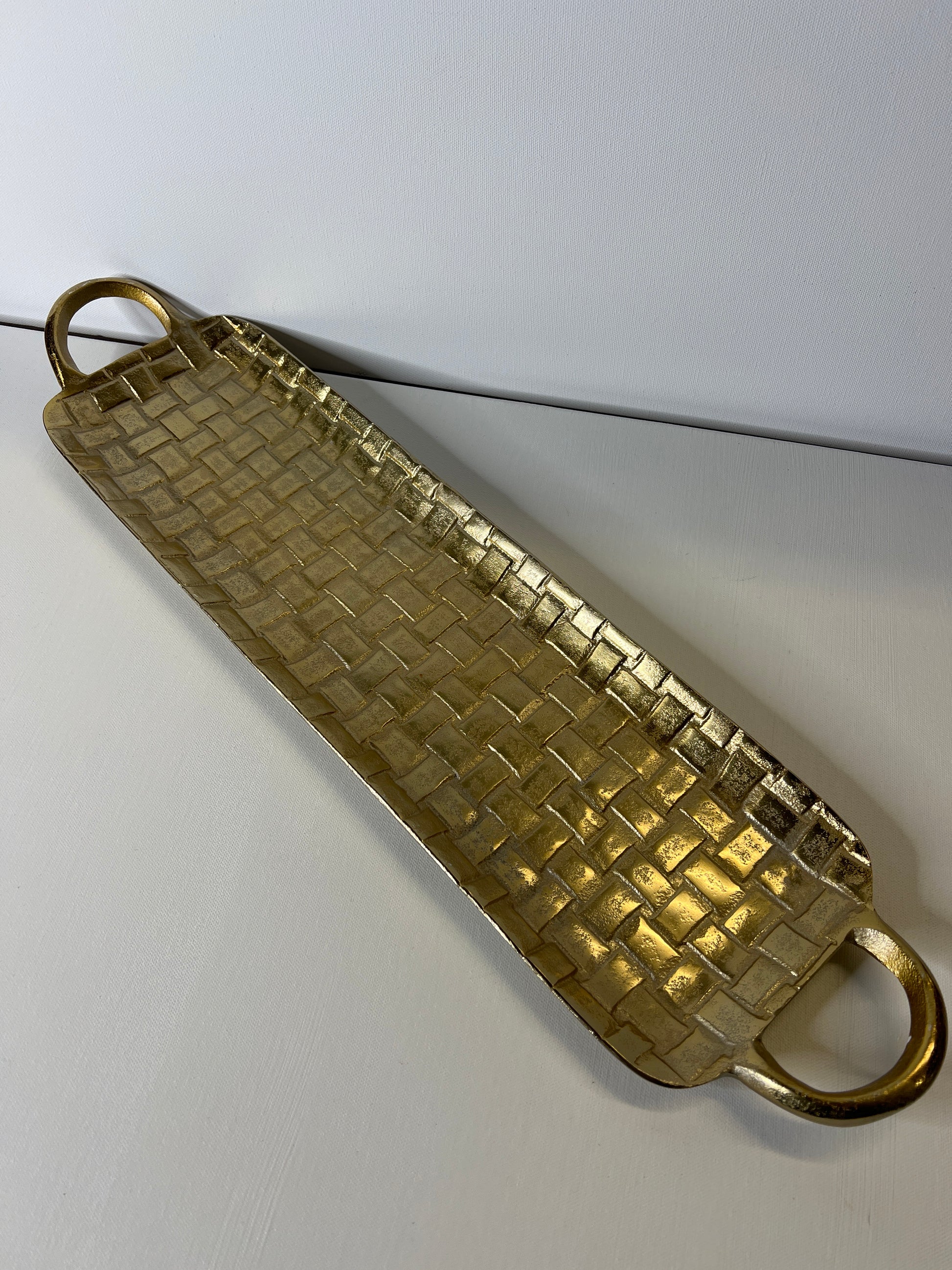 Gold textured tray on a white background