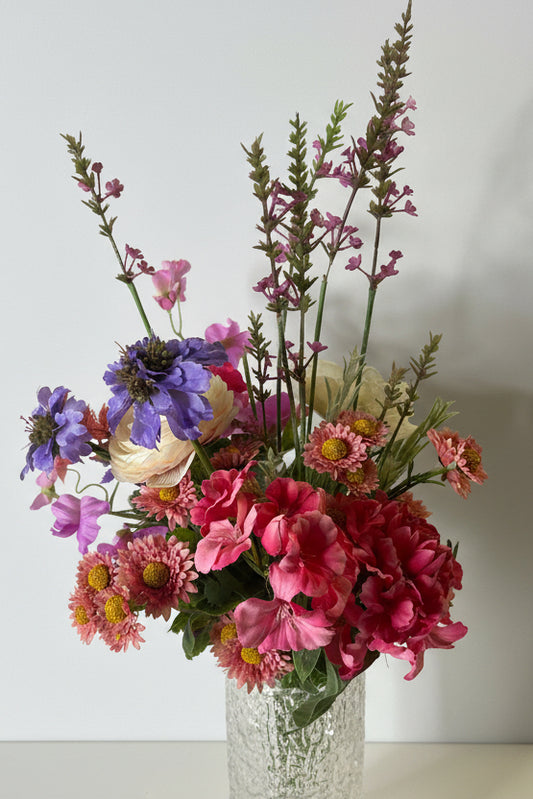 Bouquet of flowers with pink, purple, and green colors on a white background