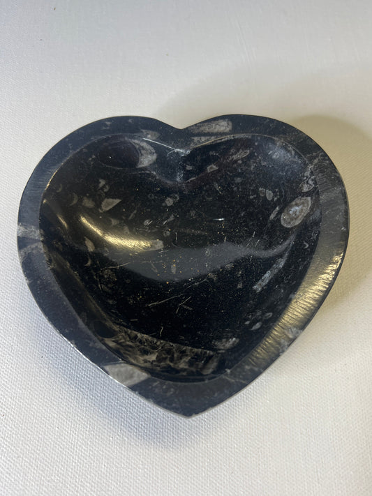 Black stone with a unique pattern on a white fabric background