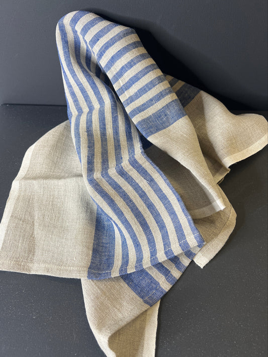 Beige and blue striped fabric on a dark background